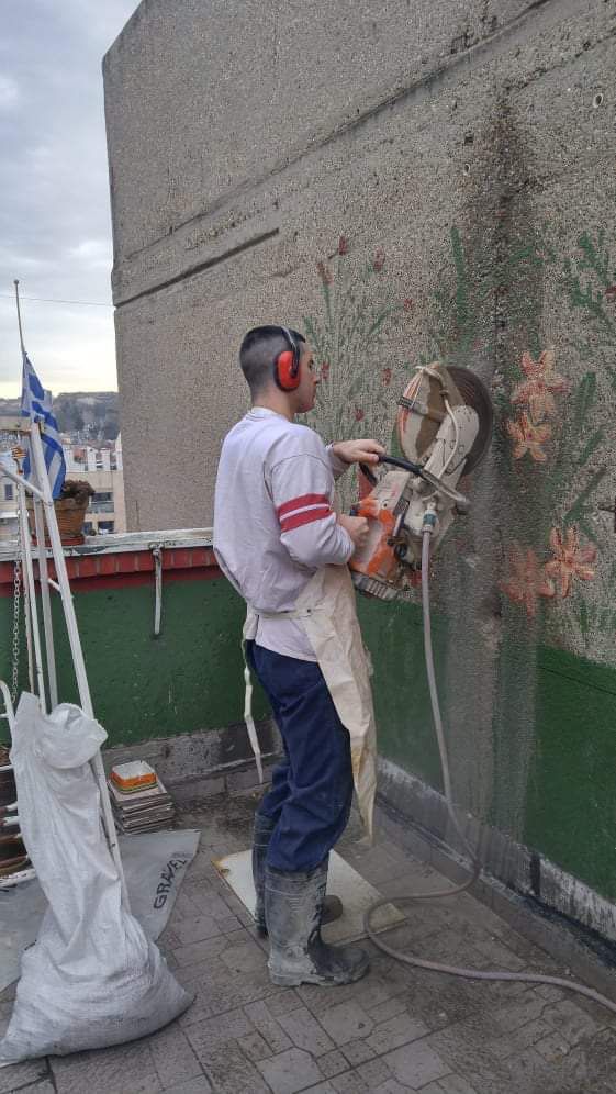 a man drilling a wall with a drill